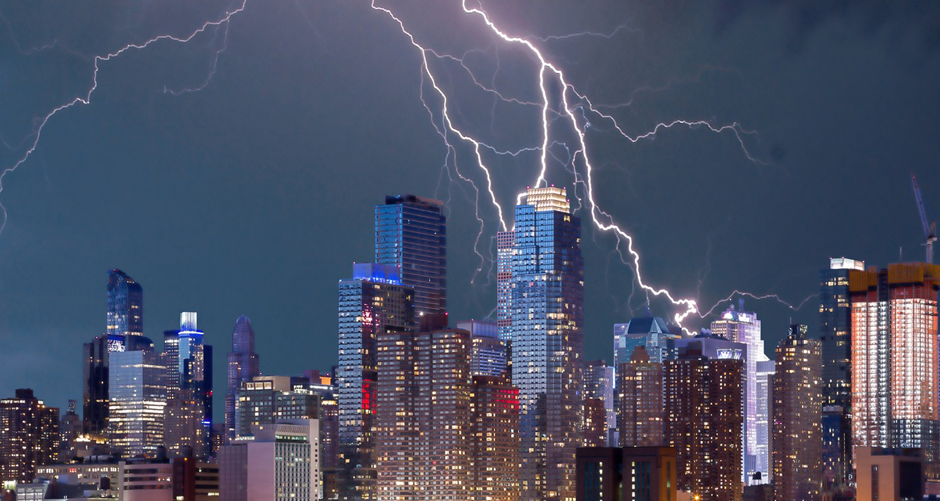 An electrical storm - with lightening - over a city center.