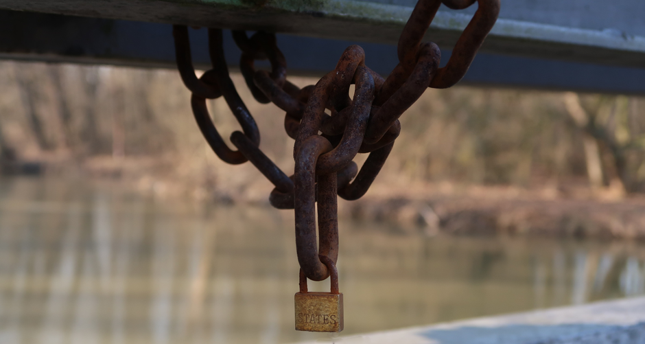 Photo of a rusty chain and a padlock